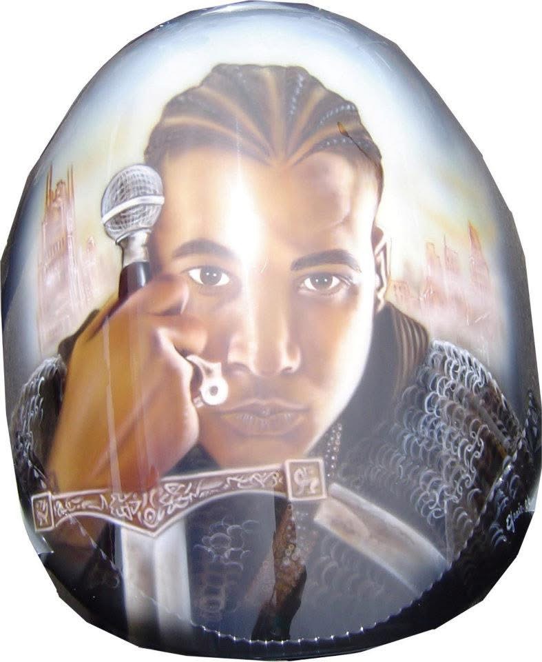 Motorcycle gas tank airbrushed with a detailed portrait and city skyline